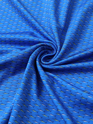 Close-up of blue swordfish golf performance print boys golf polo fabric showing moisture-wicking texture 