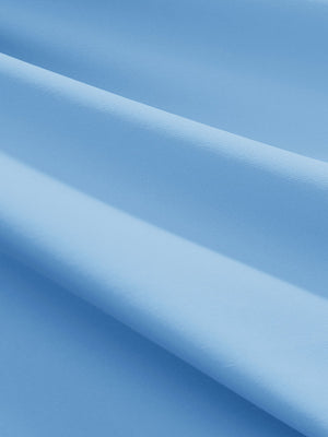 Close-up texture of light blue women's athletic quarter zip tank tops fabric showing detailed athletic material and weave.