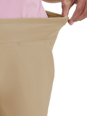 Detail view of waist stretch on light khaki women's high waist stretch golf pants with pockets