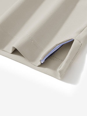 Detail view of hem on oyster gray dry fit waffle textured collared golf shirts