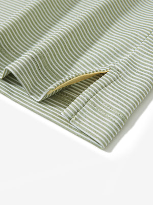 Detail view of hem on moss green white comfy breathable pin-stripe texture golf polos