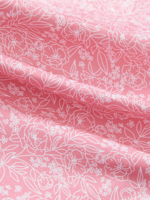Close-up texture of pink white florals women's sleeveless v-neck print golf shirts fabric showing printed weave detail.