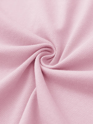 Fabric close-up of pink cotton blend pique plain shirt, breathable pique fabric texture.