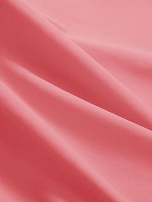 Close-up texture of pink women's athletic quarter zip tank tops fabric showing detailed athletic material and weave.