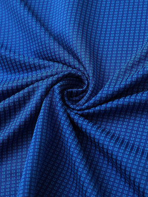 Close-up of cobalt elegant performance jacquard polo fabric showing refined texture and subtle pattern.