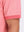 Detail view of hem on brick red moisture wicking jacquard golf shirts