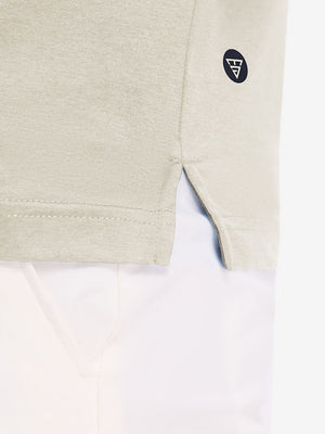 Hem detail close-up in light khaki heather of performance heather contrast collar polo shirts.