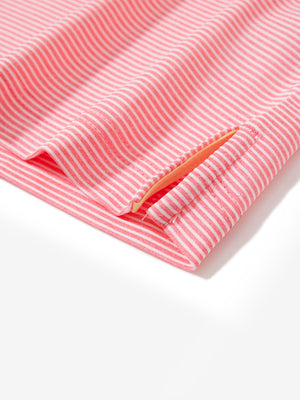 Detail view of hem on pink coral white comfy breathable pin-stripe texture golf polos