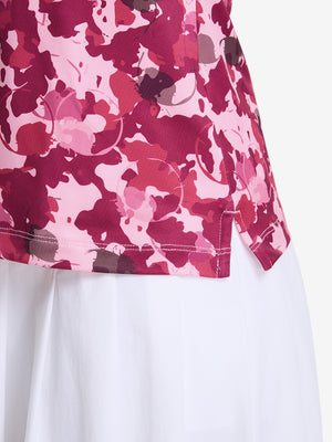 Detail view of hem on red splatter women's sleeveless q-zip print quick dry golf tops
