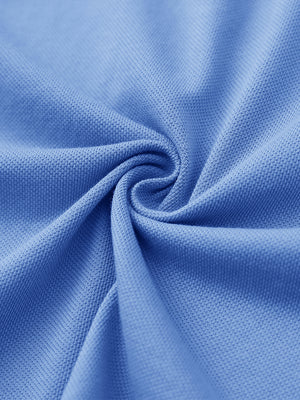 Fabric close-up of blue cotton blend pique plain shirt, breathable pique fabric texture.