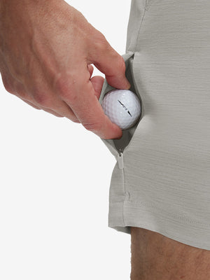 Detail view of back pocket on light gray flat front hybrid golf shorts