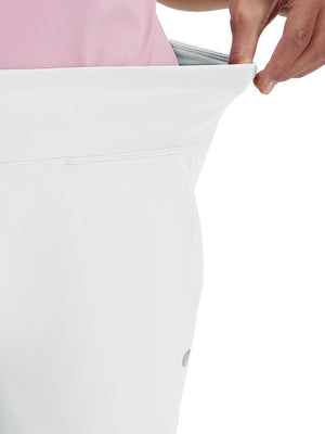 Detail view of waist stretch on white women's high waist stretch golf pants with pockets