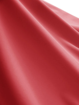 Close-up texture of pink women's moisture-wicking mock neck sleeveless golf tops fabric showing breathable weave detail.