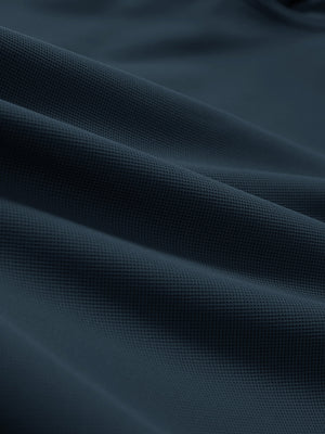 Close-up texture of navy dry fit waffle textured collared golf shirts fabric showing weave detail.