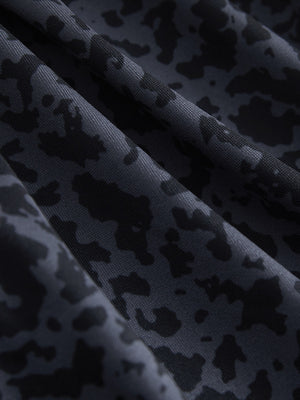 Close-up texture of black gray blocks women's sleeveless q-zip print quick dry golf tops fabric showing detailed print and quick dry weave.