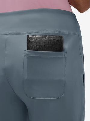 Back view of pocket on grey blue women's high waist stretch golf pants with pockets