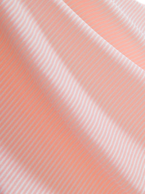 Close-up texture of light pink white comfy breathable pin-stripe texture golf polos fabric showing weave detail.