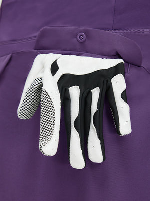 Detail view of pocket on dark purple women's stretch a-line golf skort with 7 pockets