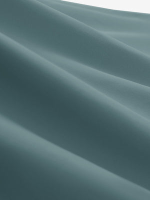 Close-up texture of dusty blue women's collared v neck quick dry tank tops fabric showing weave detail.
