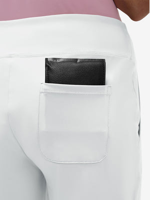 Back view of pocket on white women's high waist stretch golf pants with pockets
