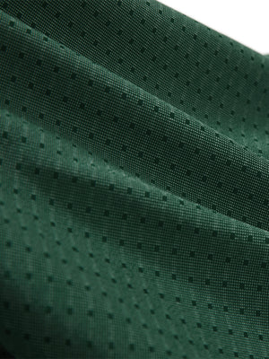 Close-up texture of green classic lightweight jacquard golf shirts fabric showing jacquard weave detail.