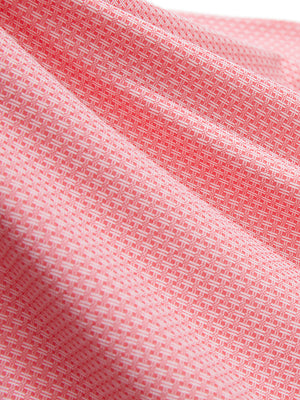 Close-up texture of brick red moisture wicking jacquard golf shirts fabric showing detailed jacquard weave and wicking texture.