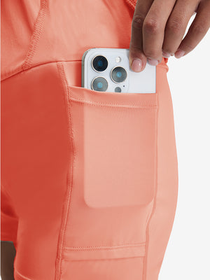 Detail view of inner pocket on peach pink women's stretch a-line golf skort with 7 pockets