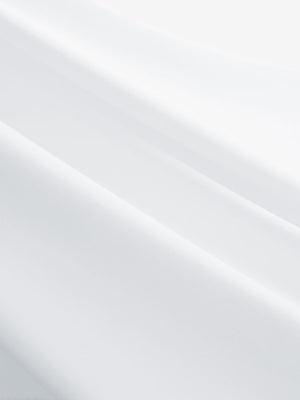 Close-up texture of white women's 5 buttons collared polo shirts fabric showing detailed knit weave.