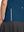 Detail view of hem design on blue women's breathable 1/4 zip pullover golf shirts