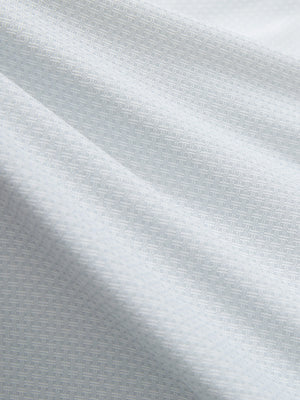 Close-up texture of light grey moisture wicking jacquard golf shirts fabric showing detailed jacquard weave and wicking texture.
