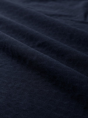 Clear close-up of exquisite jacquard fabric grain and nylon blend texture, nylon blend casual jacquard polo shirts in navy