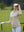 The model is wearing Women's Water-Resistant Stretch Fleece Lined Jacket light khaki on the golf course.