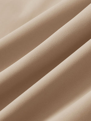 Close-up texture of light khaki 4 way stretch breathable workout athletic shorts fabric showing weave detail.