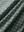 Close-up texture of dark green leaves stylish full print contrast collared golf polo shirts fabric showing weave detail.