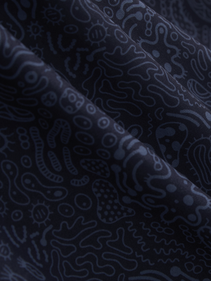 Close-up texture of navy graffiti stylish full print contrast collared golf polo shirts fabric showing weave detail.