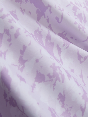 Close-up texture of violet frost flowers stylish full print contrast collared golf polo shirts fabric showing weave detail.