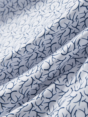 Close-up texture of navy antlers stylish full print contrast collared golf polo shirts fabric showing weave detail.
