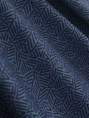 Close-up texture of navy lines stylish full print contrast collared golf polo shirts fabric showing weave detail.