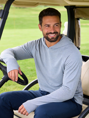 Model sitting on golf cart in white light blue grid ultra-light soft moisture wicking hoodies pullover